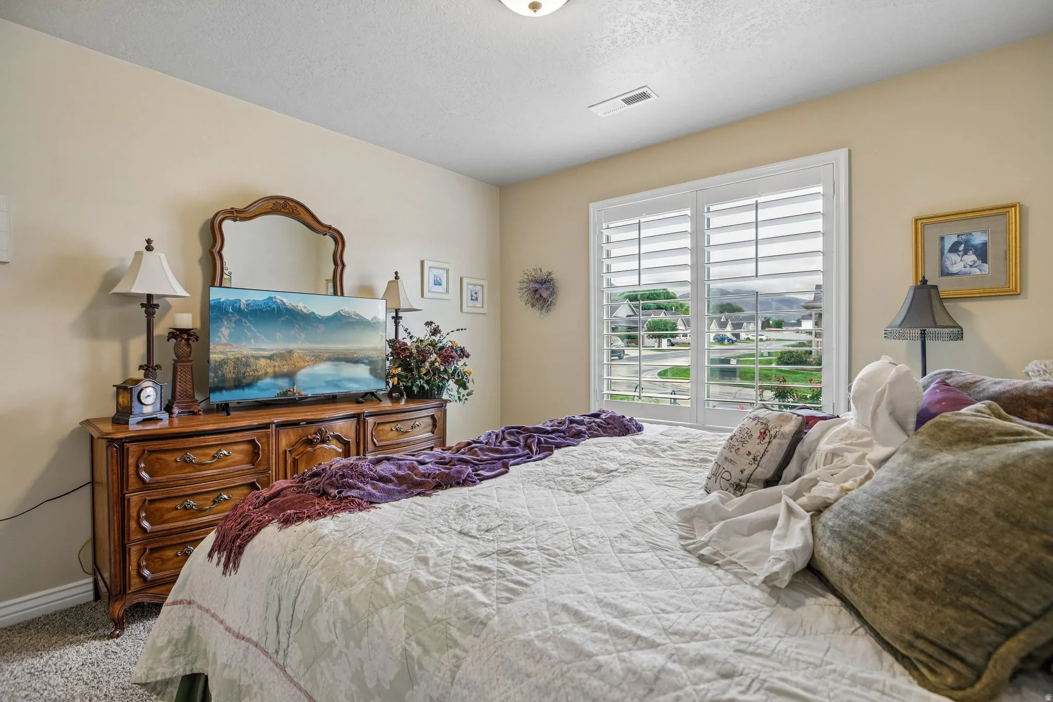 Recessed lighting, warm neutral wall tones, and plantation shutters