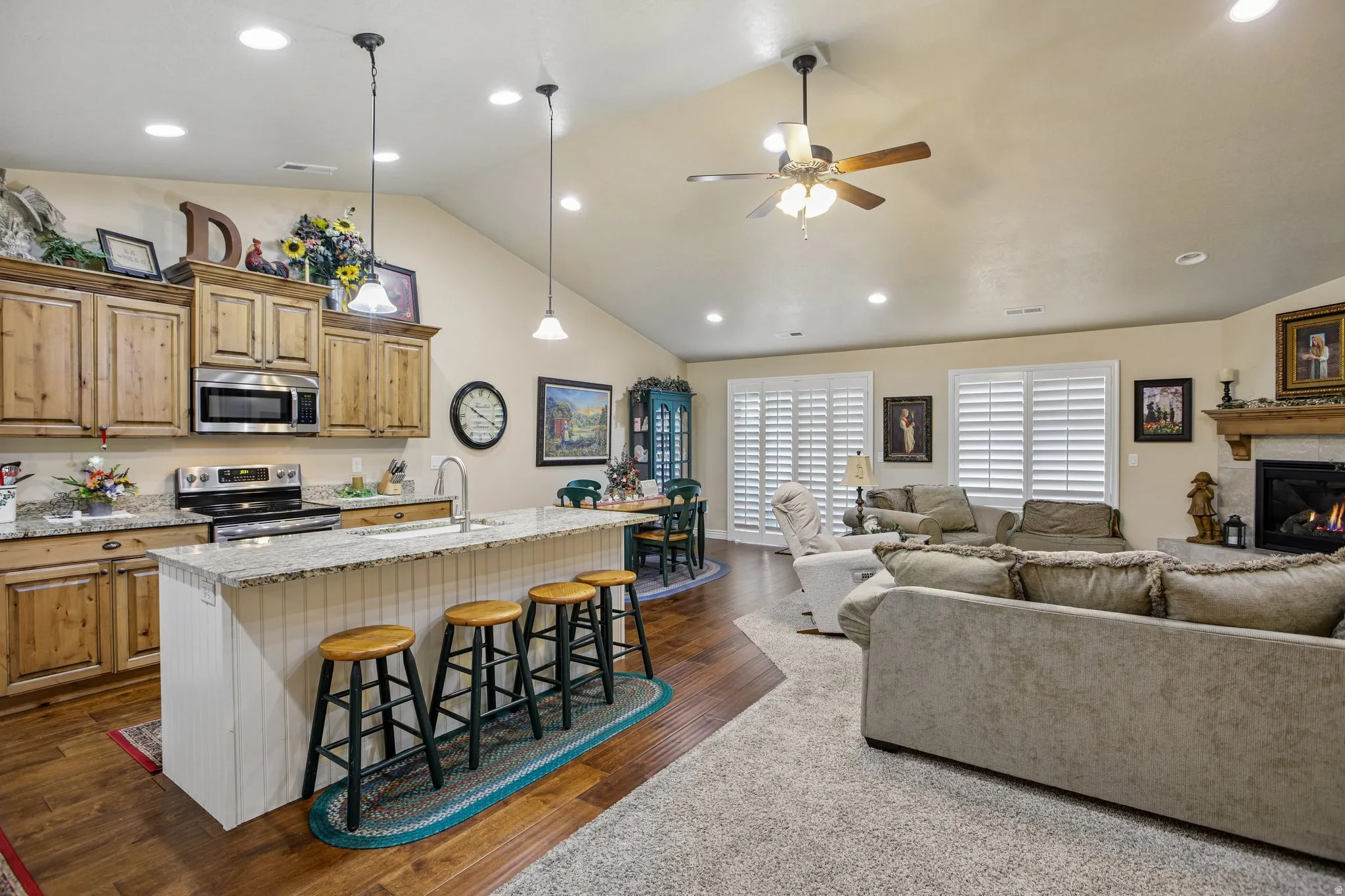 Kitchen featuring wood cabinetry, stainless steel appliances, and a central island with a granite-style countertop