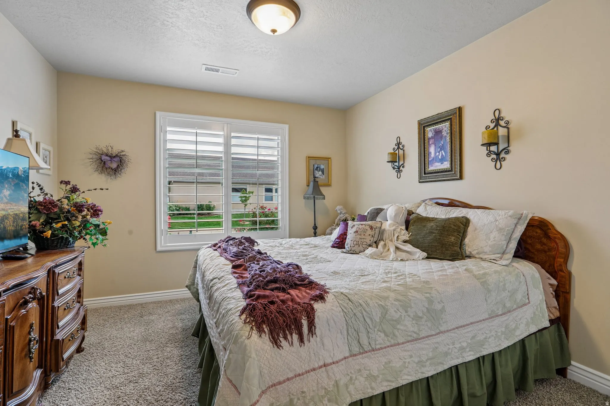 Window with white plantation shutters and trim