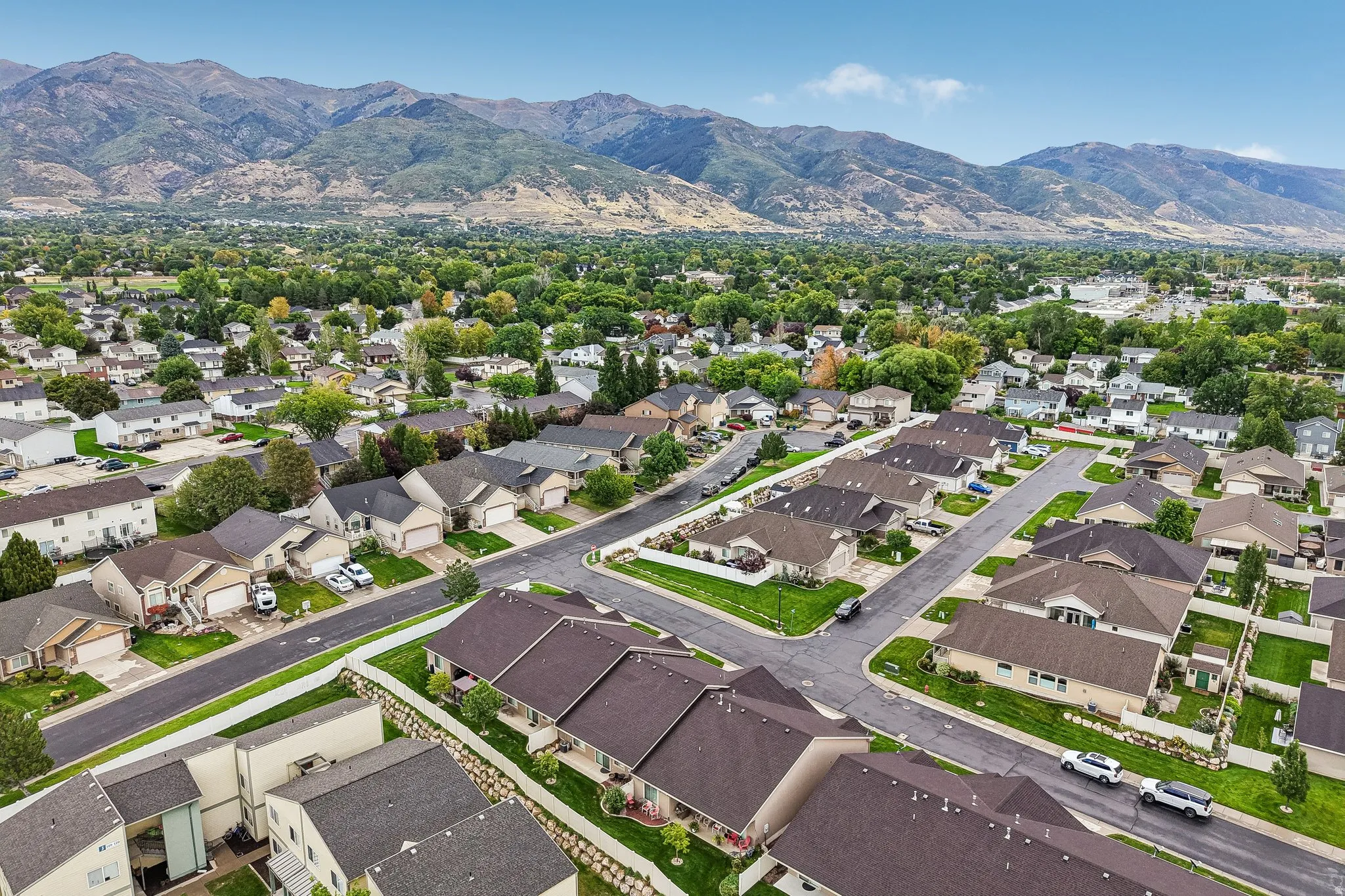 Residential neighborhood with established landscaping and mountain backdrop