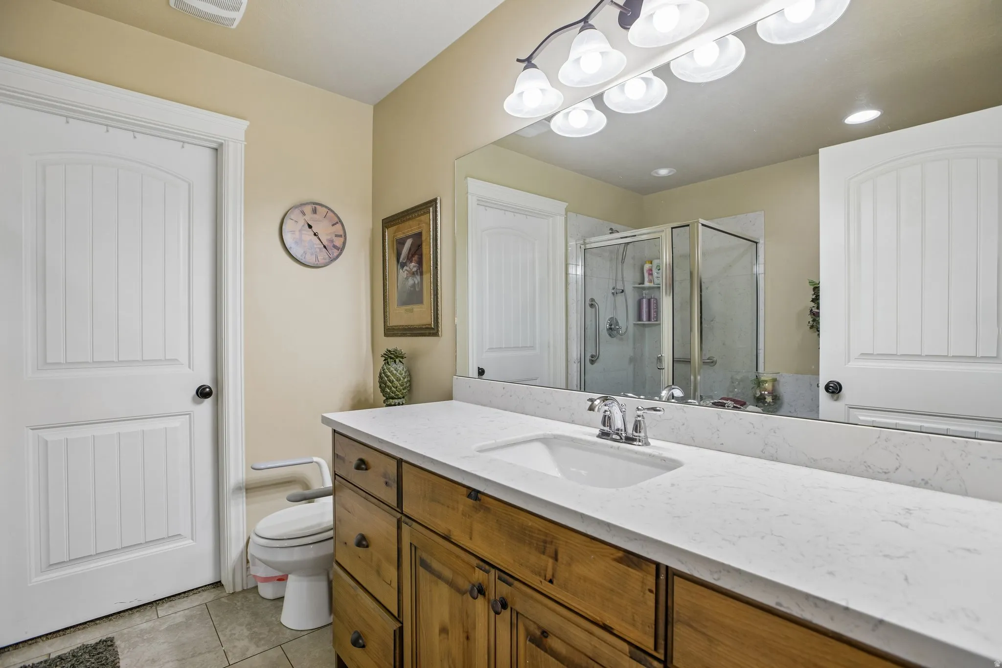 Wood-finish cabinetry with a white countertop and integrated sink