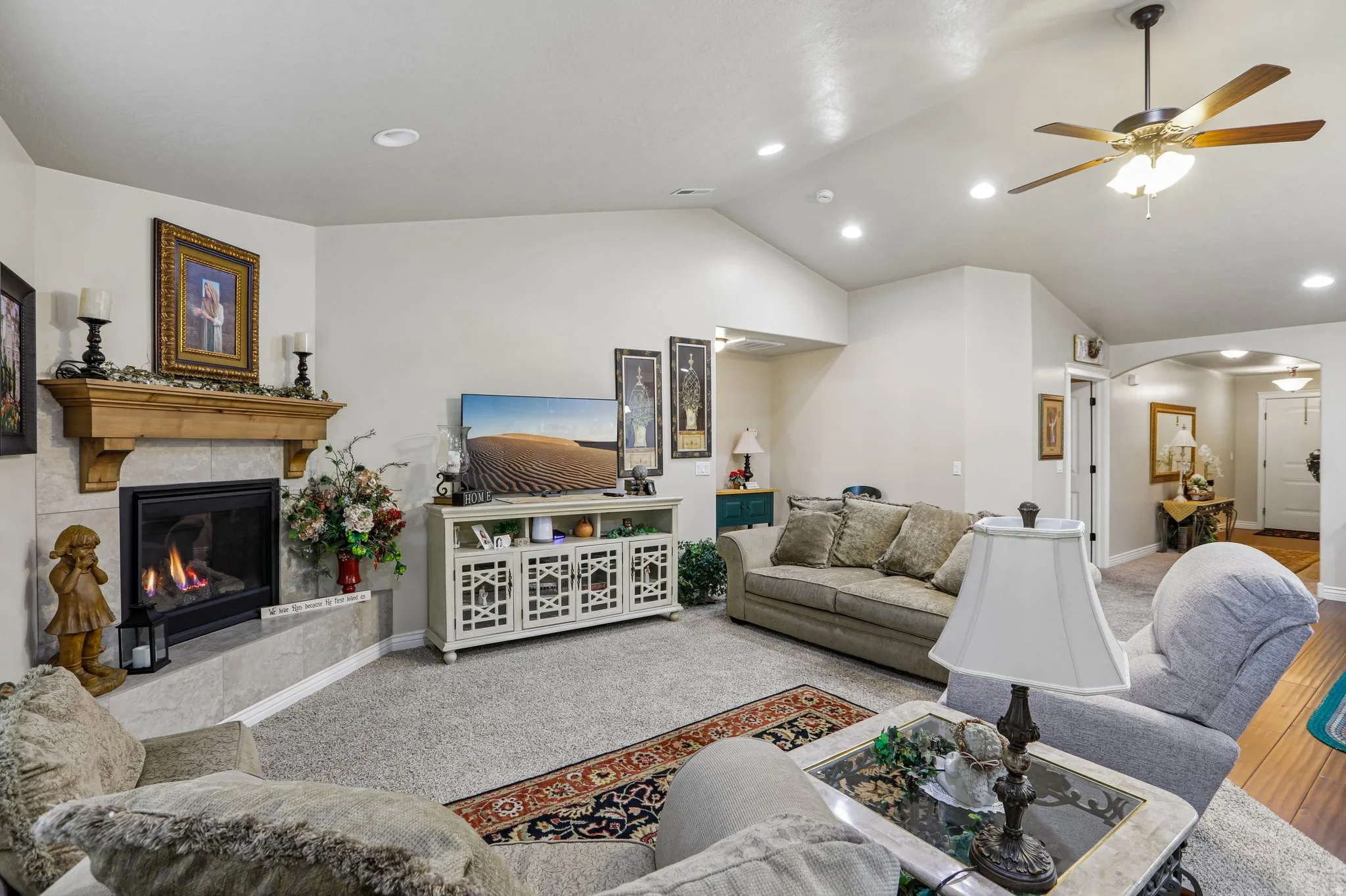 Recessed lighting illuminates vaulted ceilings with a ceiling fan