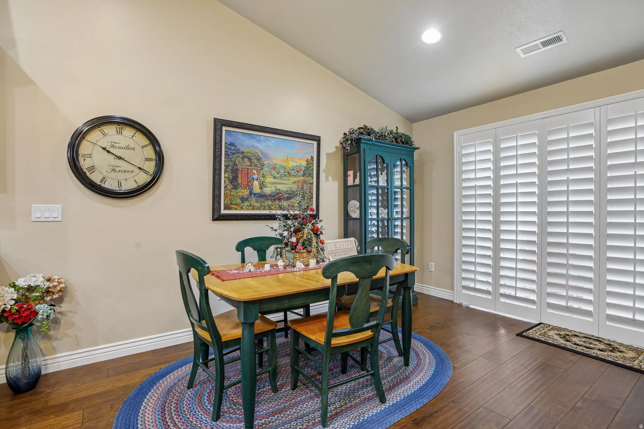 Hardwood-finish flooring, vaulted ceiling, recessed lighting, and expansive window shutters