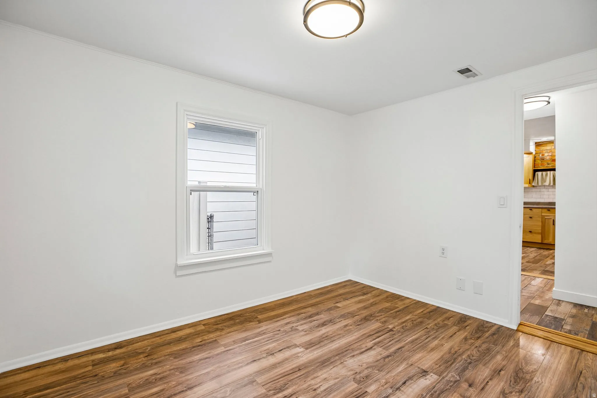 White walls with wood-finish flooring