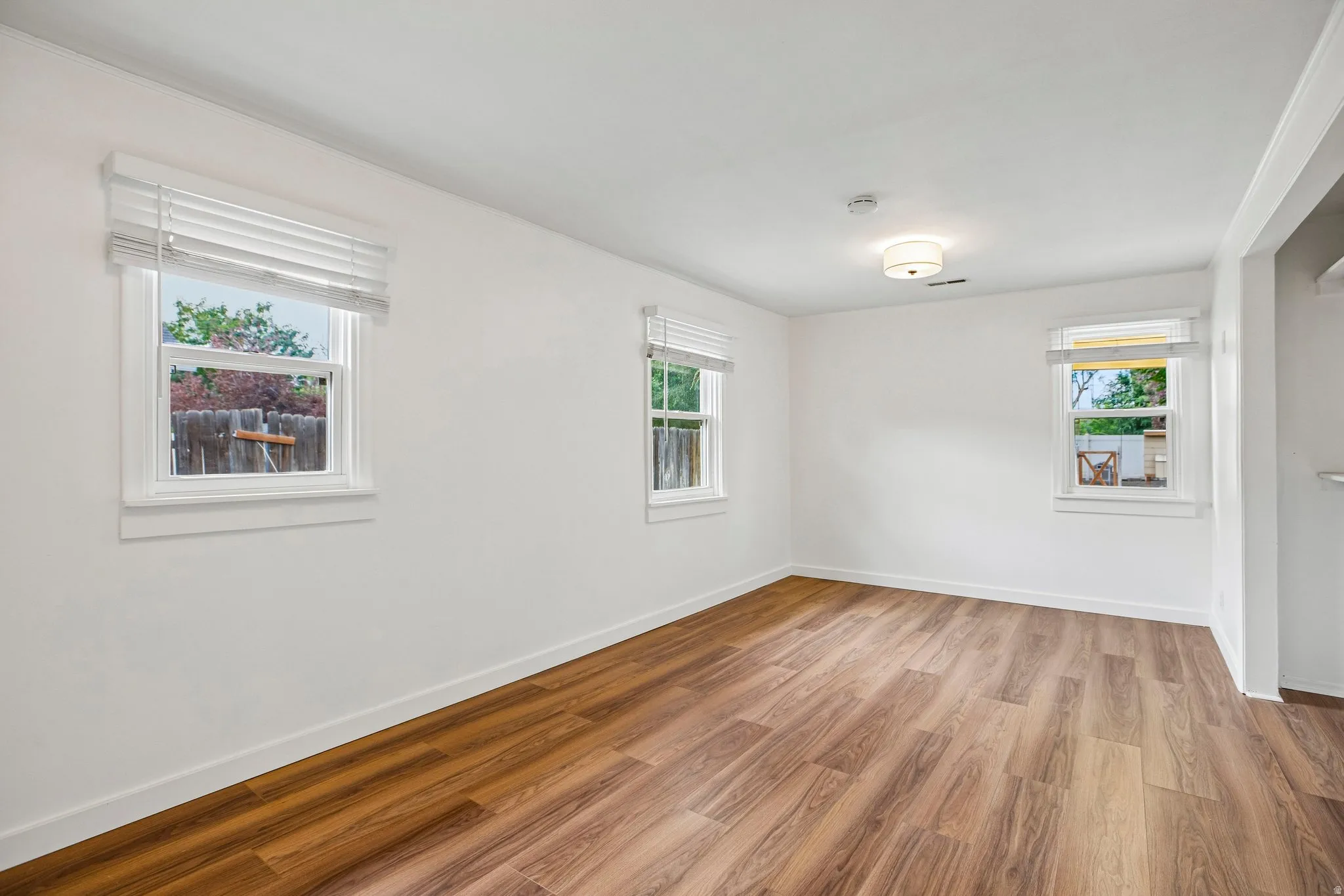Wood-finish flooring with white walls and trim