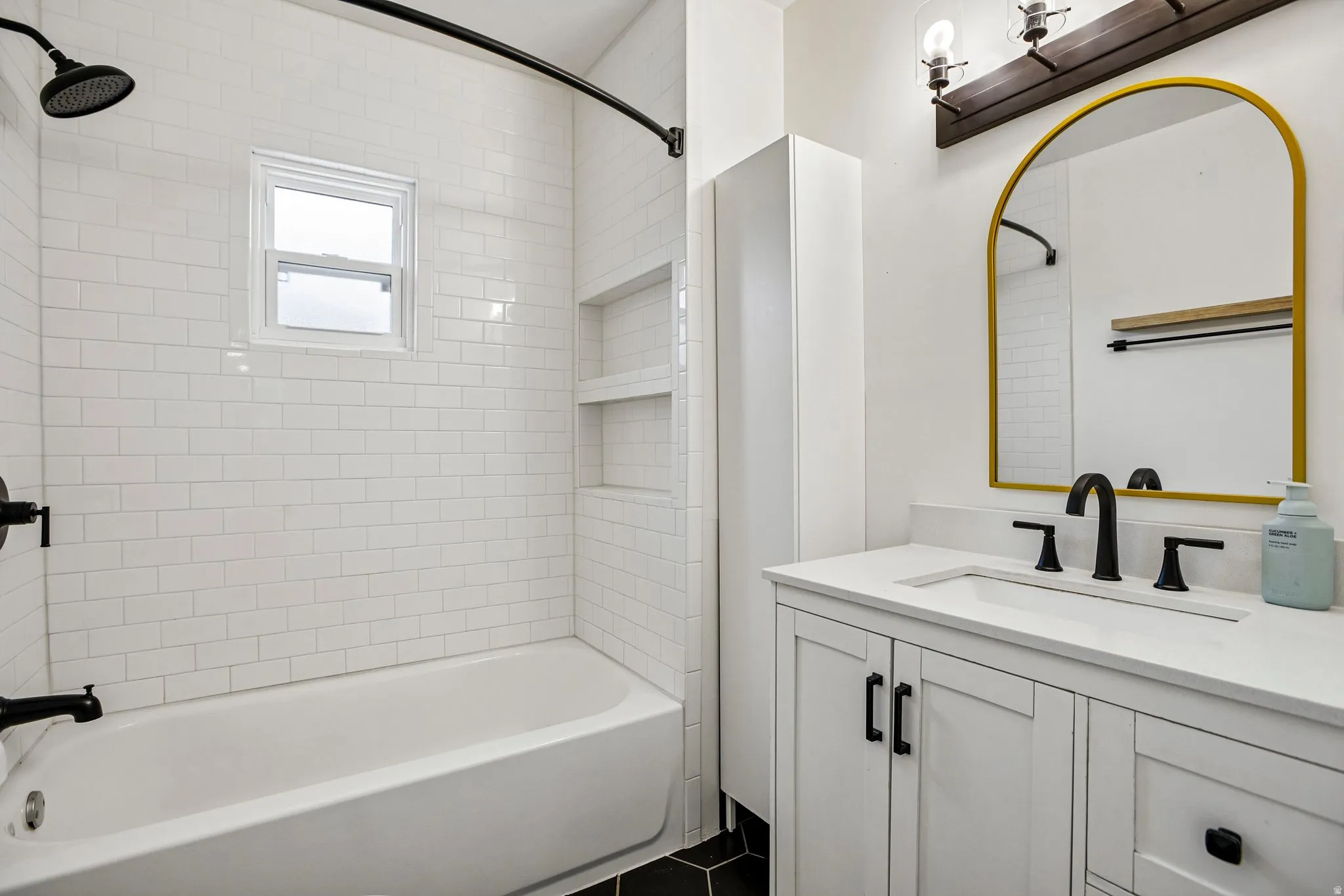 White subway tile shower surround with a window and built-in shelving