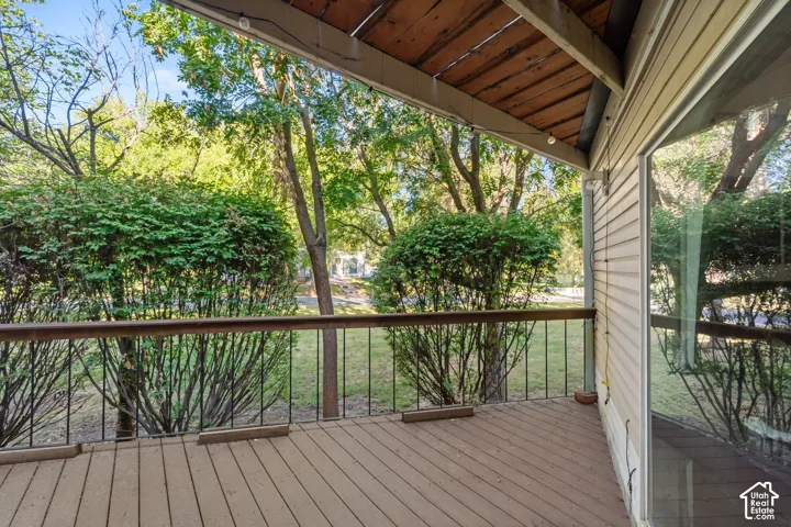 Covered outdoor deck with wood-finish flooring