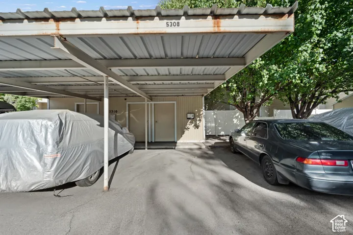 Covered parking structure with metal roofing and support beams