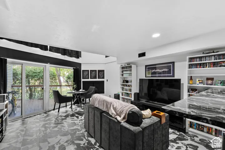 Spacious living area featuring patterned flooring, and a fireplace