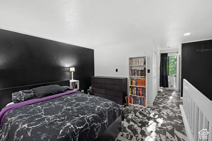 Black accent wall, white railings, dark flooring, and a window with exterior visibility