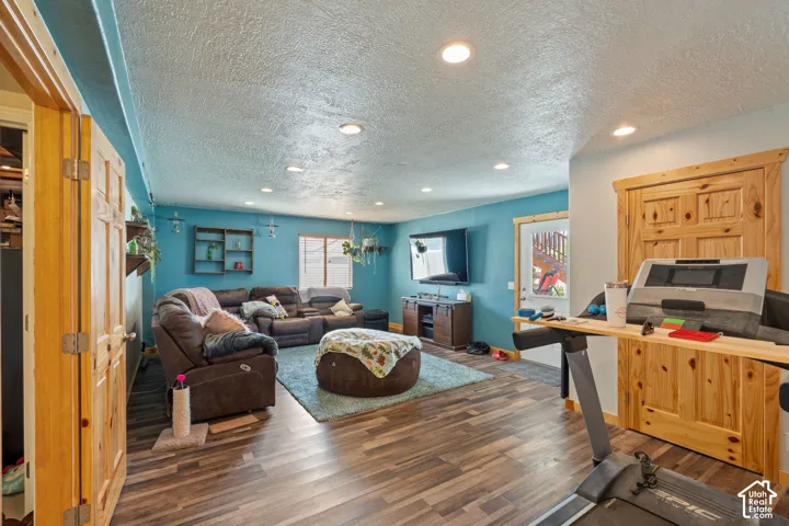 Recessed ceiling lighting, wood-finish flooring, and natural wood door casings featuring six-panel doors