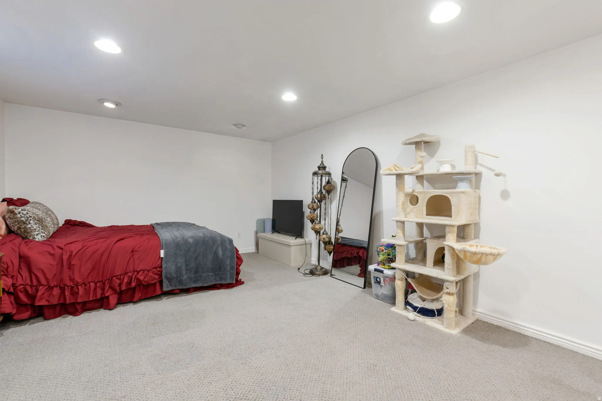 Recessed ceiling lighting, light neutral-toned carpeting, and white painted walls