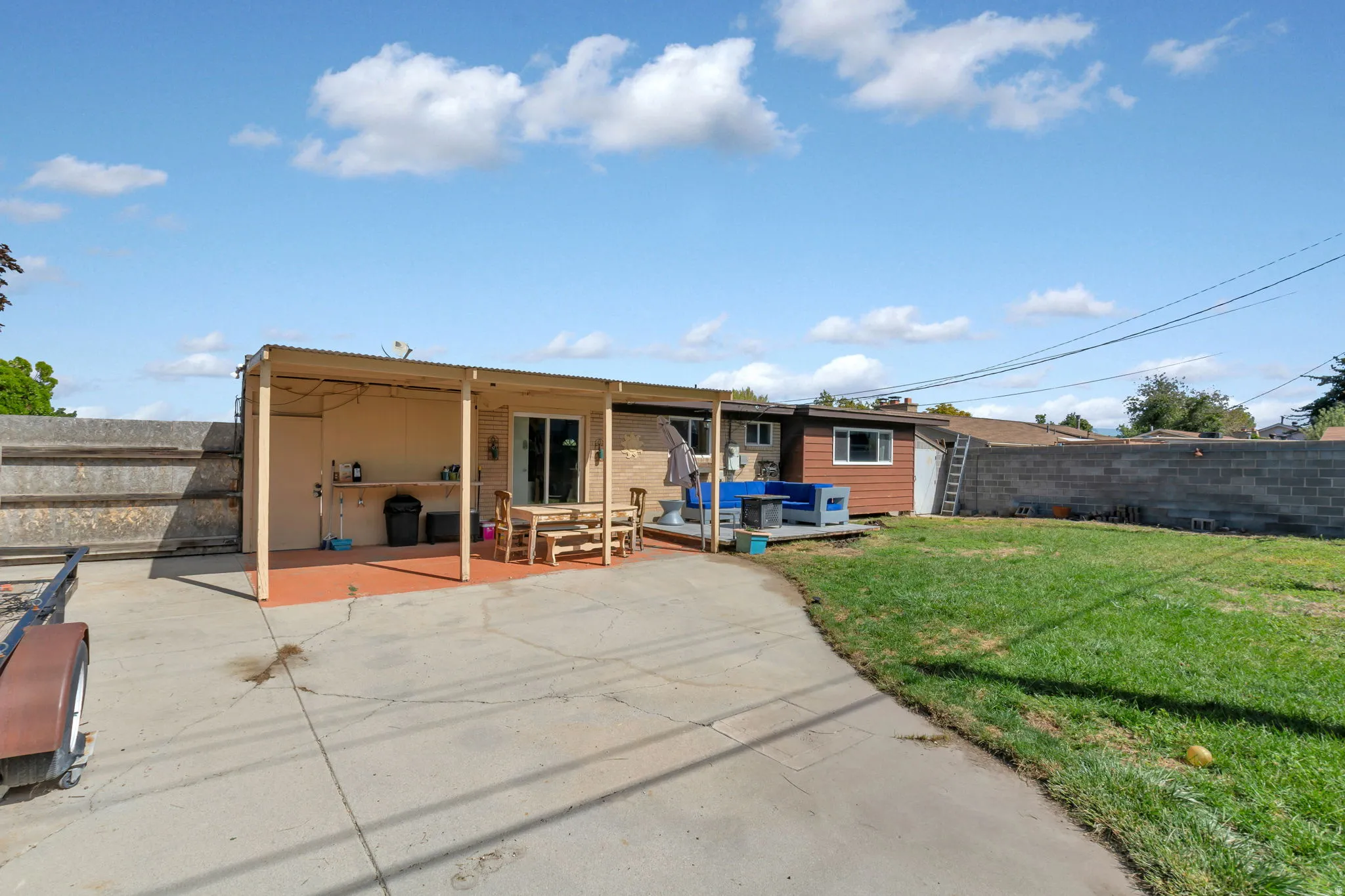 Expansive concrete patio with a covered outdoor area