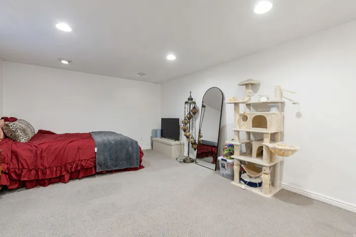 Recessed ceiling lighting, light neutral-toned carpeting, and white painted walls