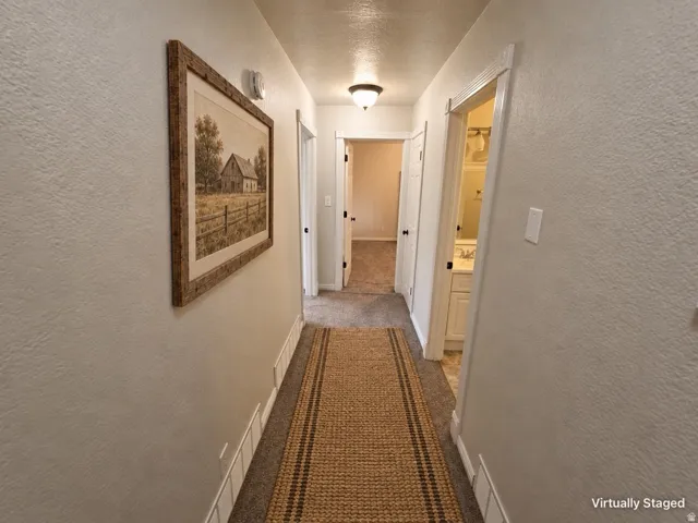 Recessed ceiling lighting illuminates the hallway with white trim details