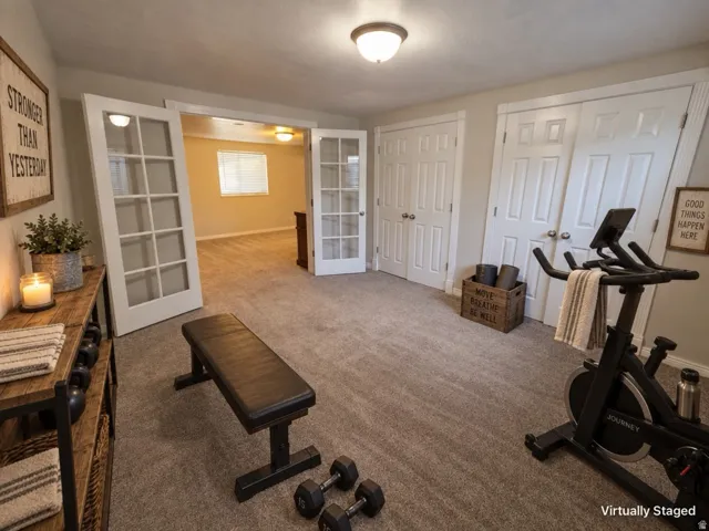 Carpeted flooring, white paneled doors, and ceiling-mounted light fixtures