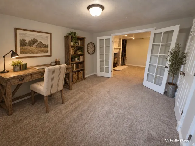 Carpeted room with double French doors and a built-in ceiling light fixture