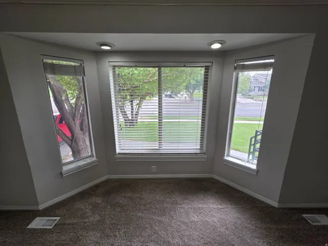 Bay window with recessed lighting and neutral wall paint