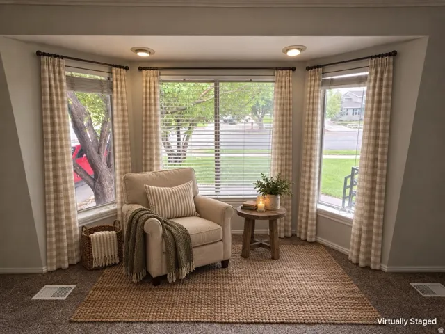 Bay window with three distinct window panels, recessed lighting, and carpeted flooring