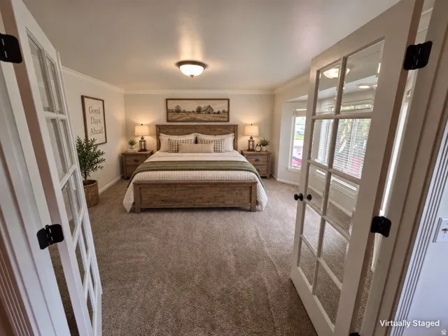 Crown molding, recessed lighting, double French doors, bay window, and soft carpet flooring
