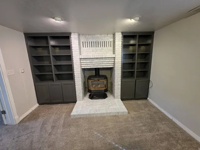 Brick fireplace with a wood-burning stove and a raised hearth