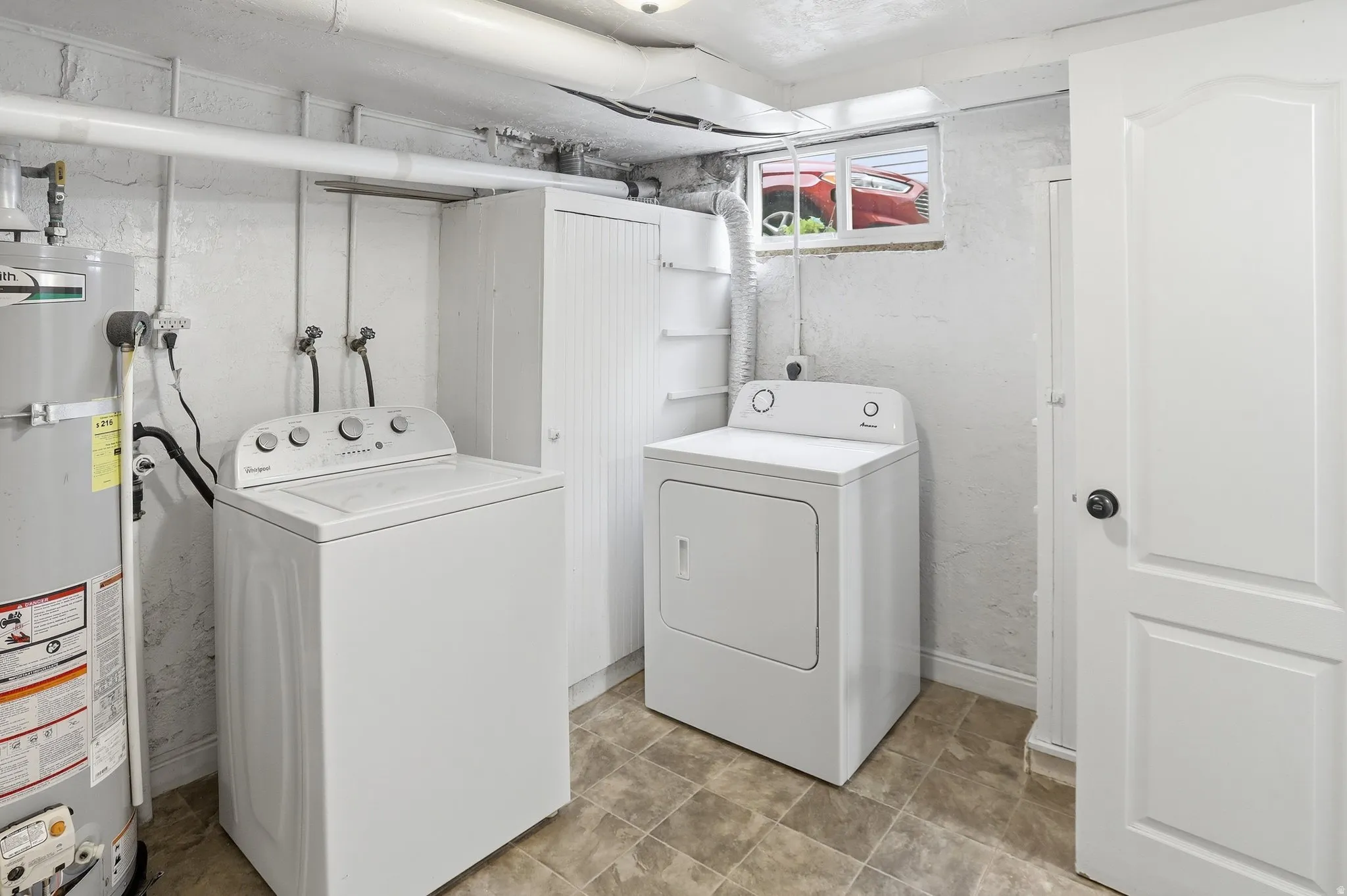 Laundry area featuring durable vinyl tile flooring