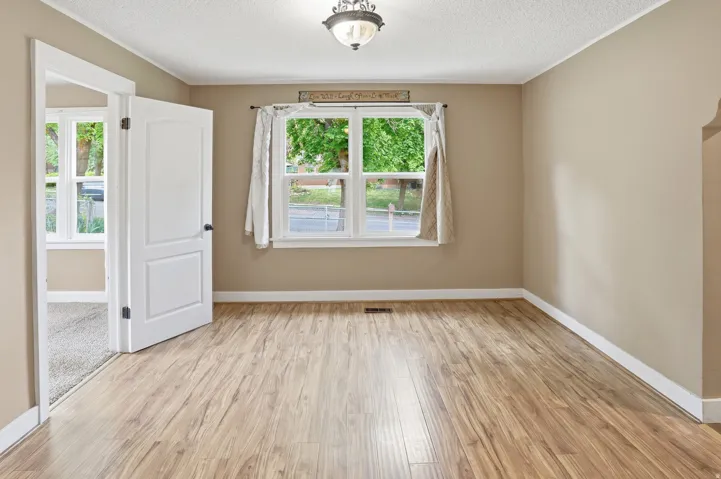 Wood-finish flooring, neutral wall tones, and white trim