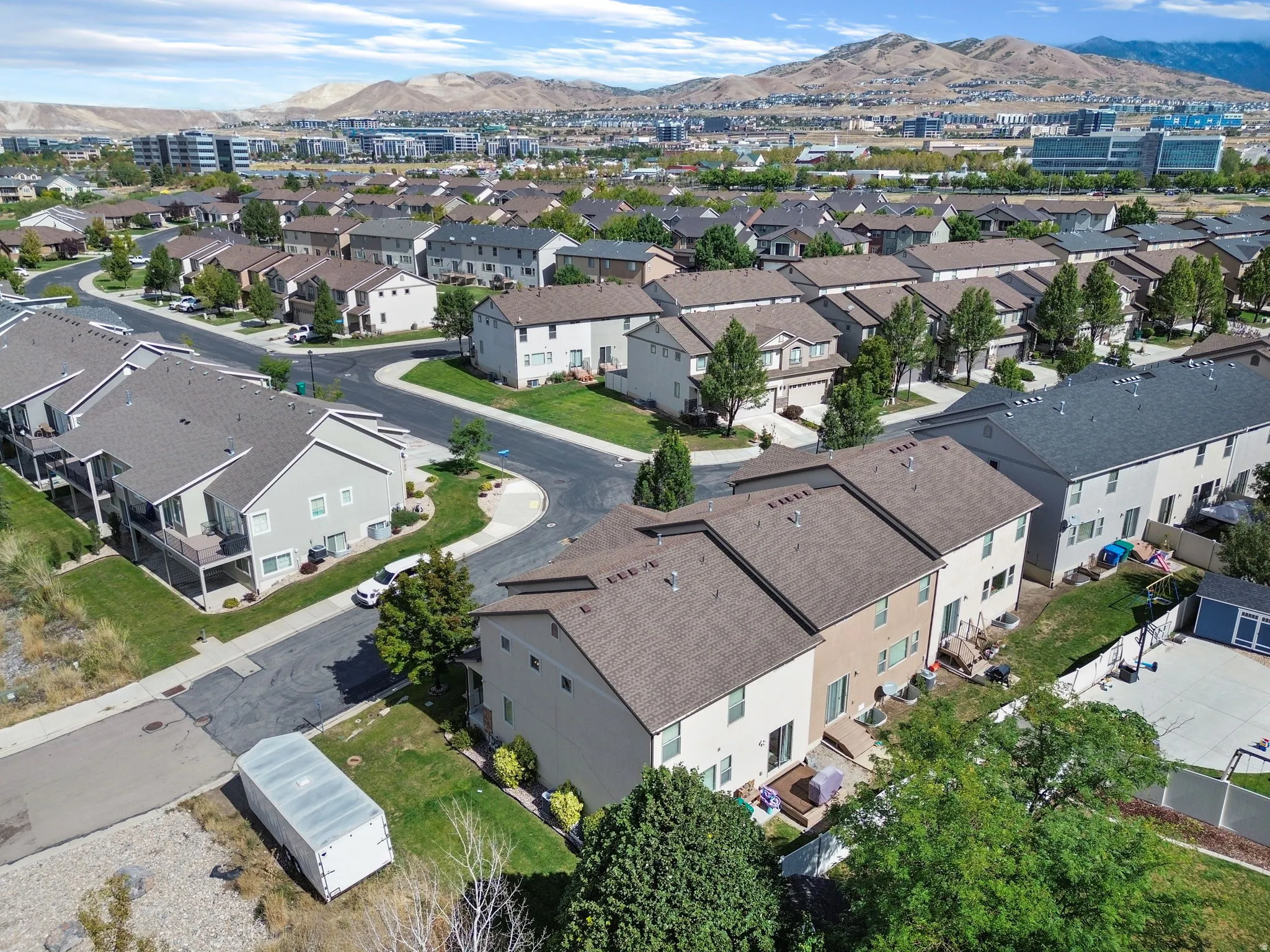 Expansive residential community with established homes, mature landscaping, and mountain scenery