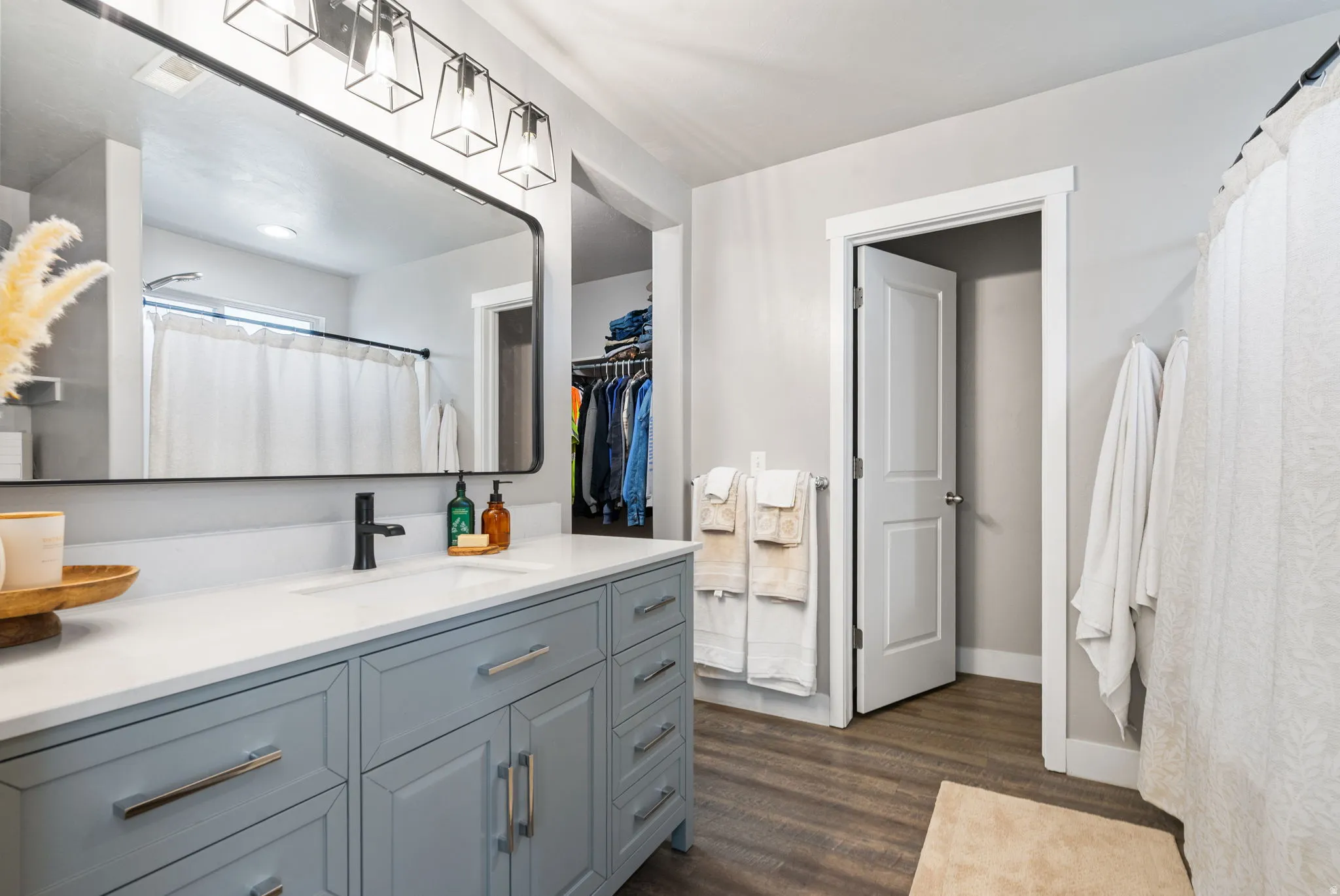 Expansive vanity featuring a light blue cabinet and white countertop