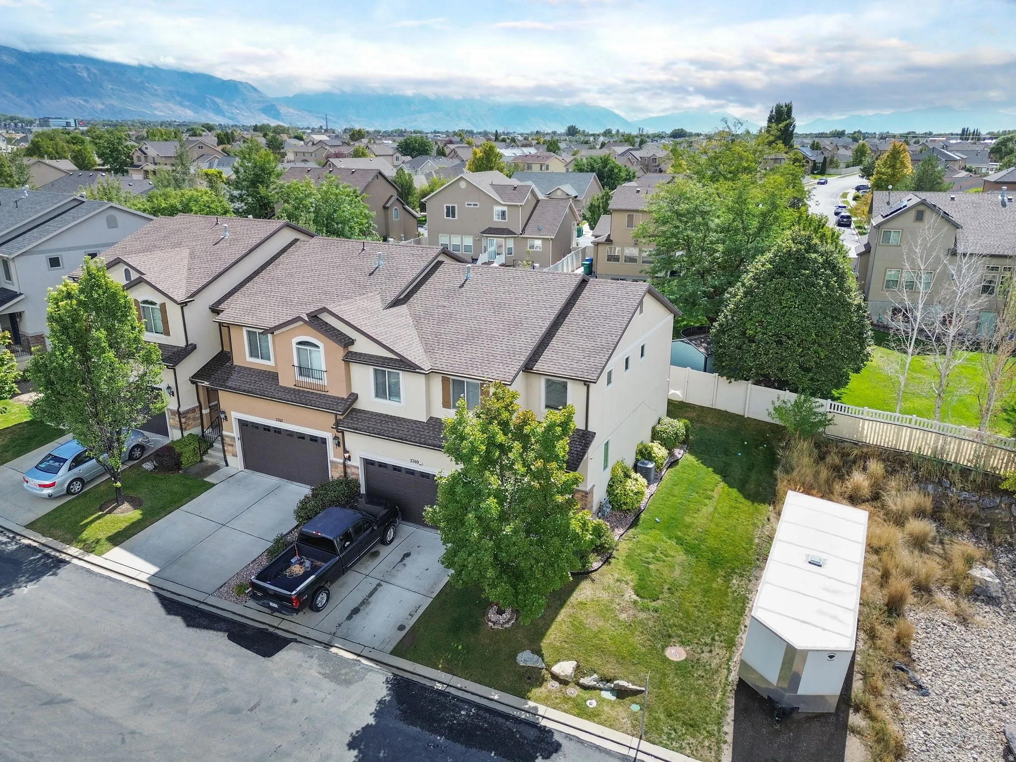 Attached multi-story residences featuring pitched shingle roofs and integrated garages