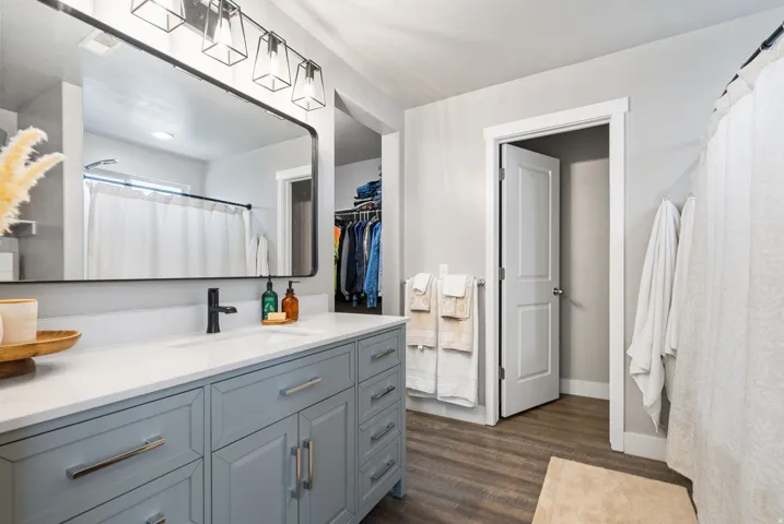 Expansive vanity featuring a light blue cabinet and white countertop