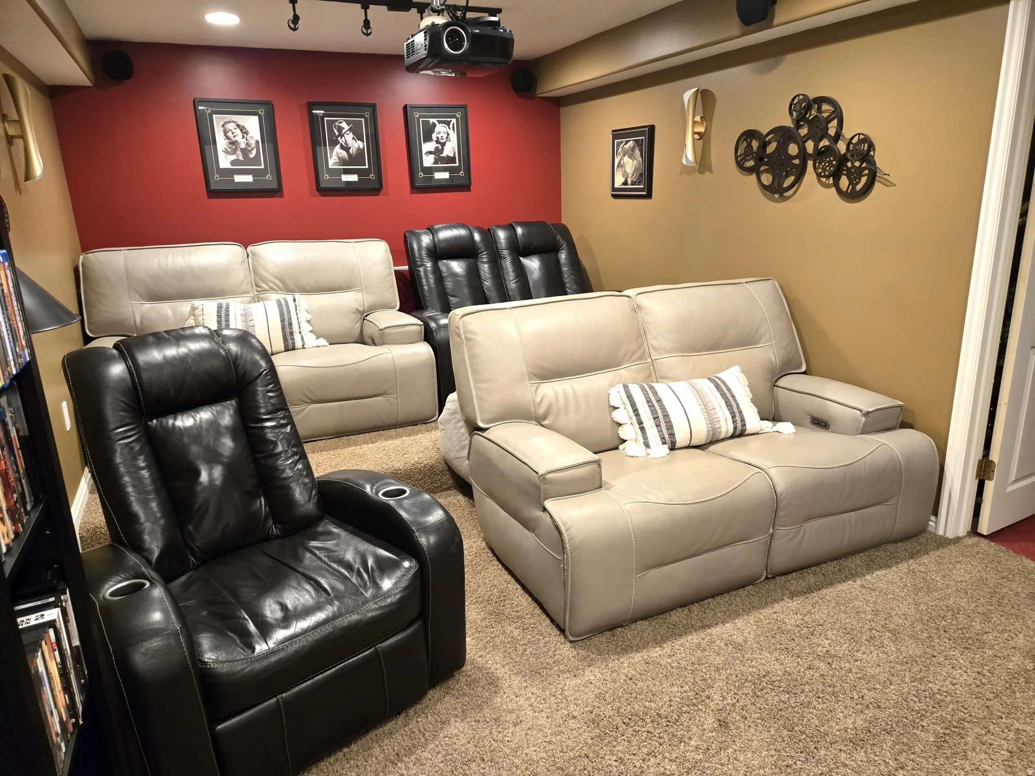 Recessed lighting, track lighting, ceiling-mounted projector, wall-mounted speakers, and textured carpeting create a dedicated media space