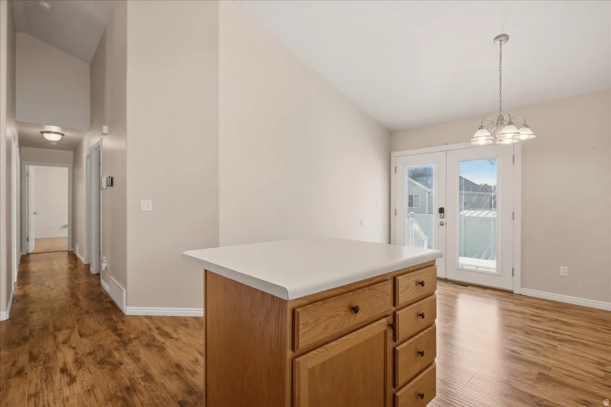 Central island with a light-toned countertop and wood-finish cabinetry