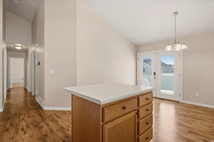 Central island with a light-toned countertop and wood-finish cabinetry