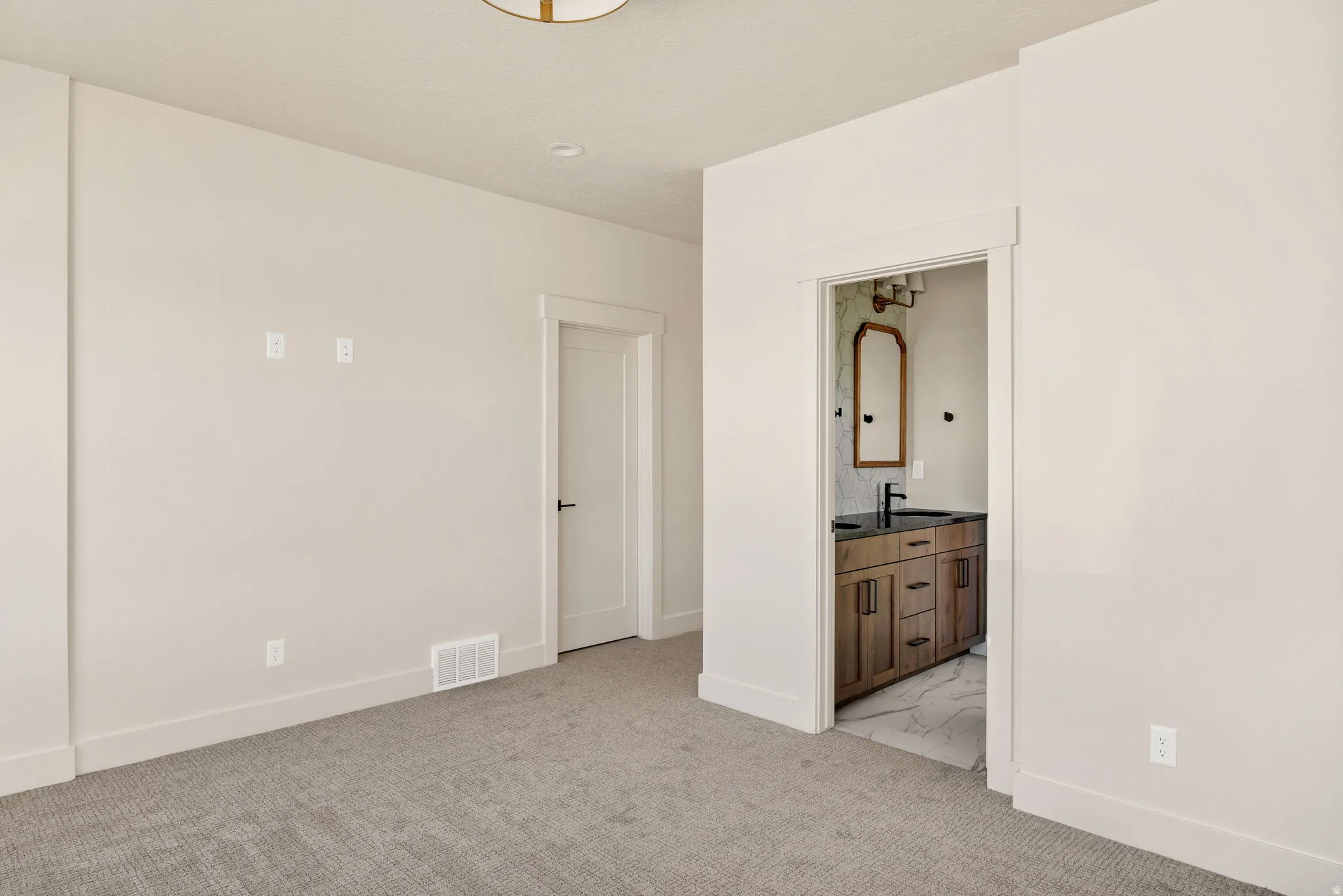 Neutral tone carpeting, recessed ceiling lighting, and a built-in ceiling light fixture