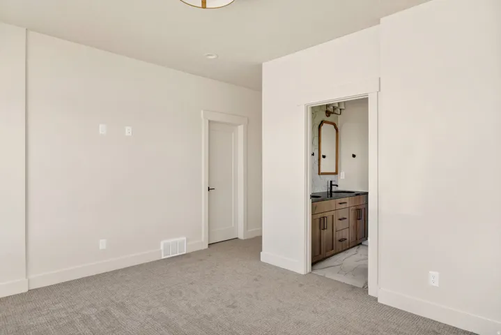 Neutral tone carpeting, recessed ceiling lighting, and a built-in ceiling light fixture
