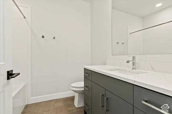 Modern vanity with a light-colored countertop, integrated sink, and chrome fixtures