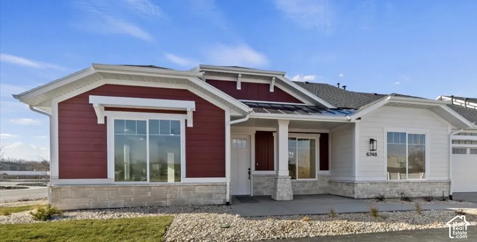 Exterior with red and white siding, stone accents, and a dark shingle roof