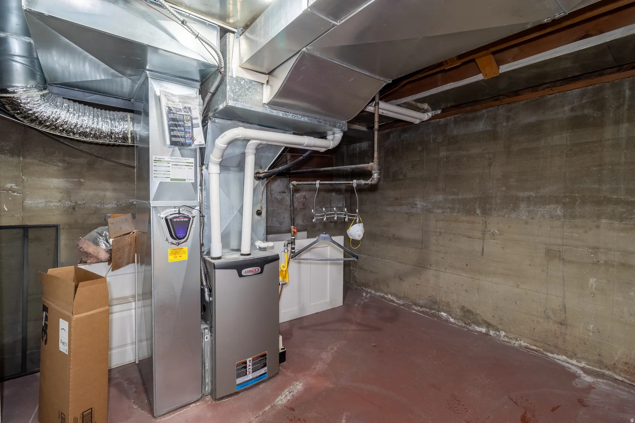 Furnace and ductwork system with concrete walls and a utility sink