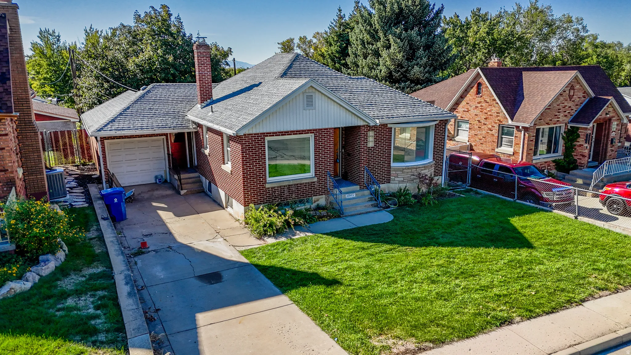 Brick exterior with white trim, a single-car garage, and a concrete driveway