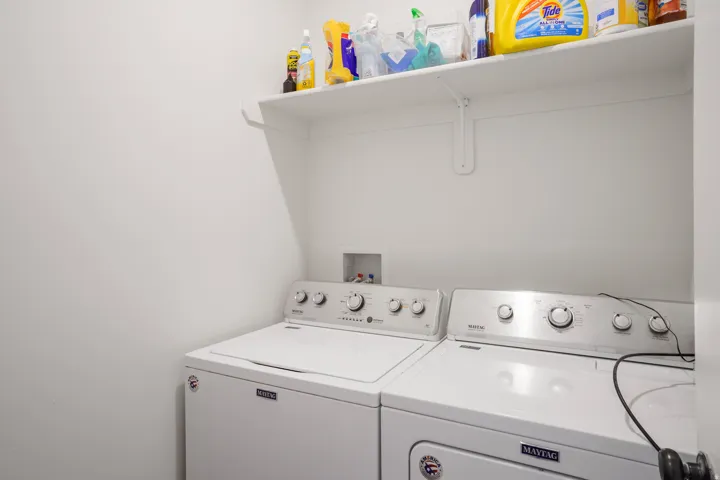 Laundry area featuring a wall-mounted shelf and appliance hookups