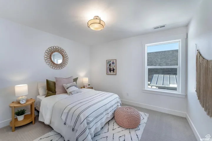 Recessed window with white trim, light-colored carpeting, and a flush-mount ceiling light fixture