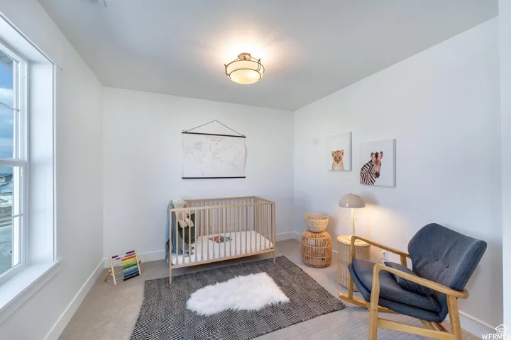 White walls, flush-mount ceiling light fixture, and a large window with white trim