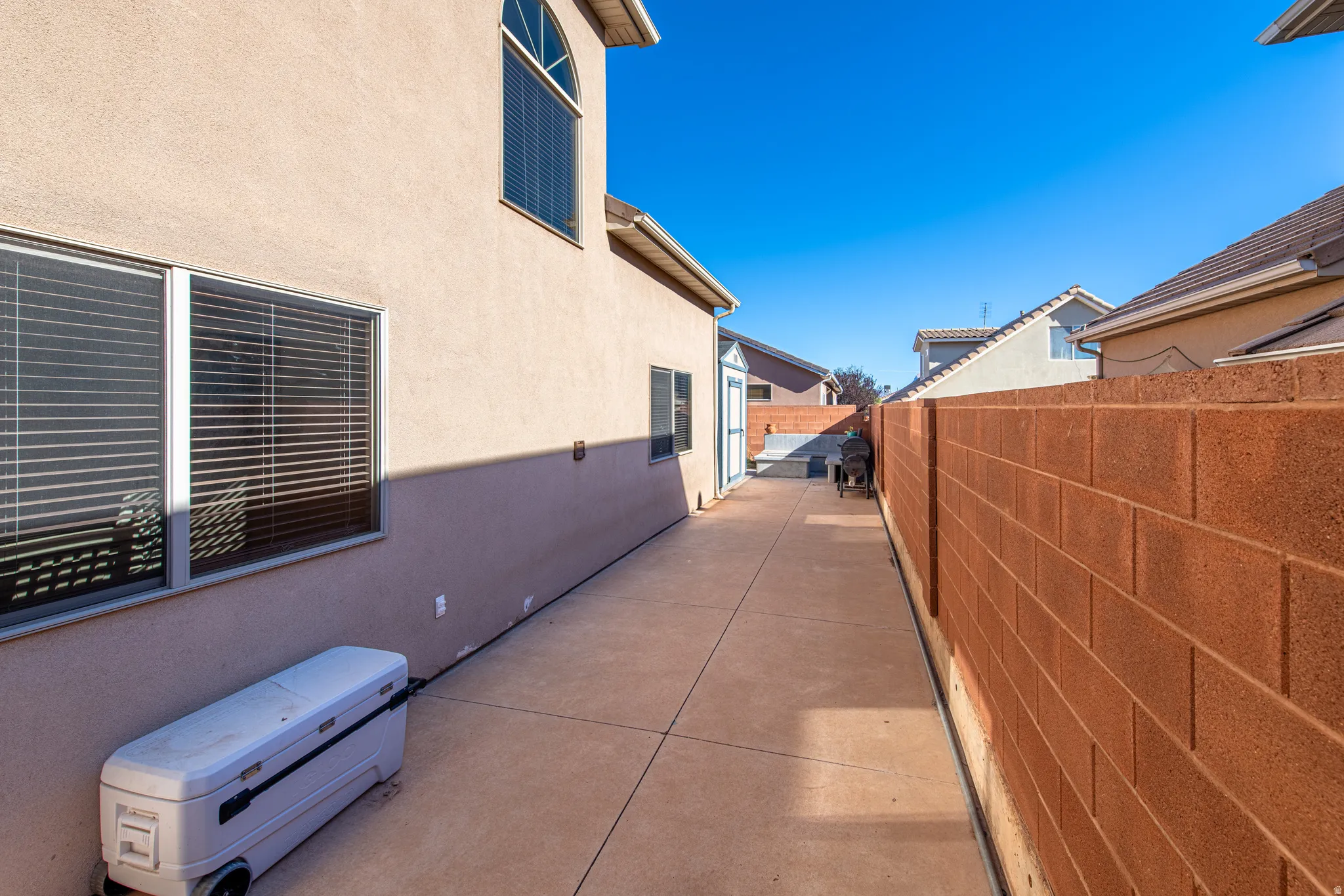 Private concrete pathway with a block perimeter wall