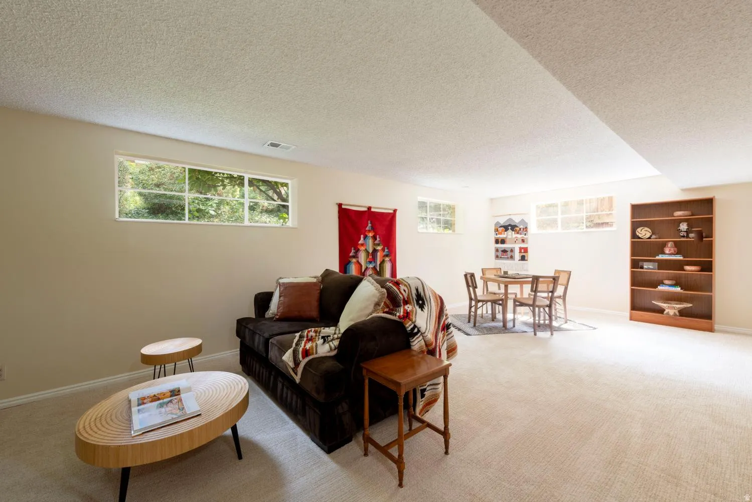 Carpeted flooring, multiple transom windows, and built-in shelving