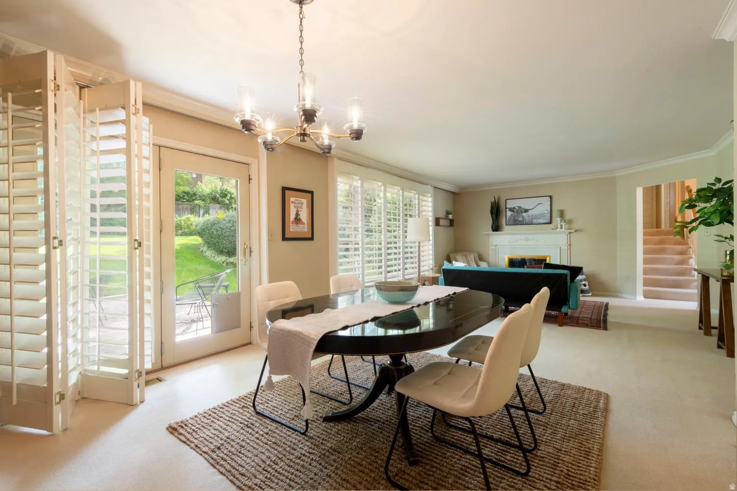 Expansive living area with a built-in fireplace, crown molding, and a chandelier