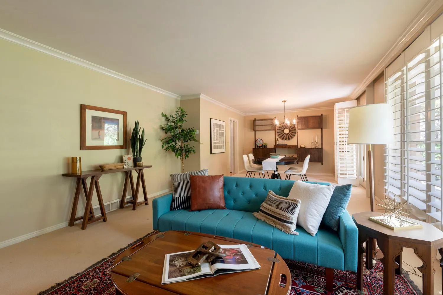 Crown molding, light-toned walls, and plantation shutters