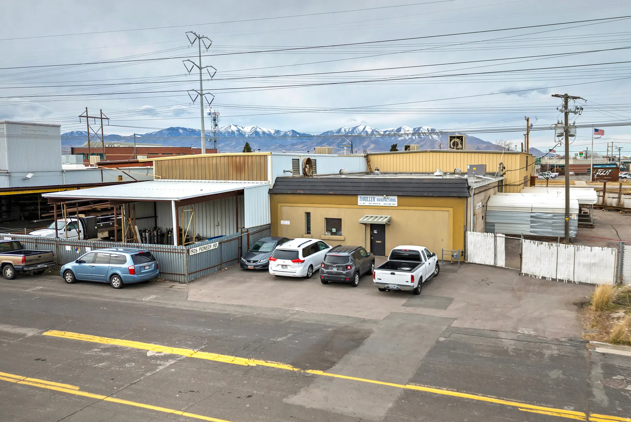 Paved front lot with ample parking and covered workspace