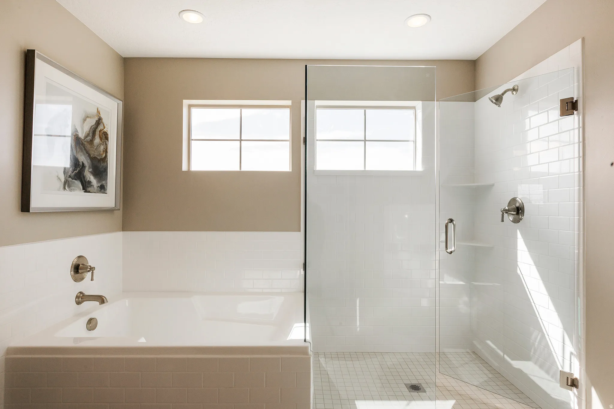 Primary Bath, White subway tile shower surround with a frameless glass door, built-in shelving, and brushed nickel fixtures