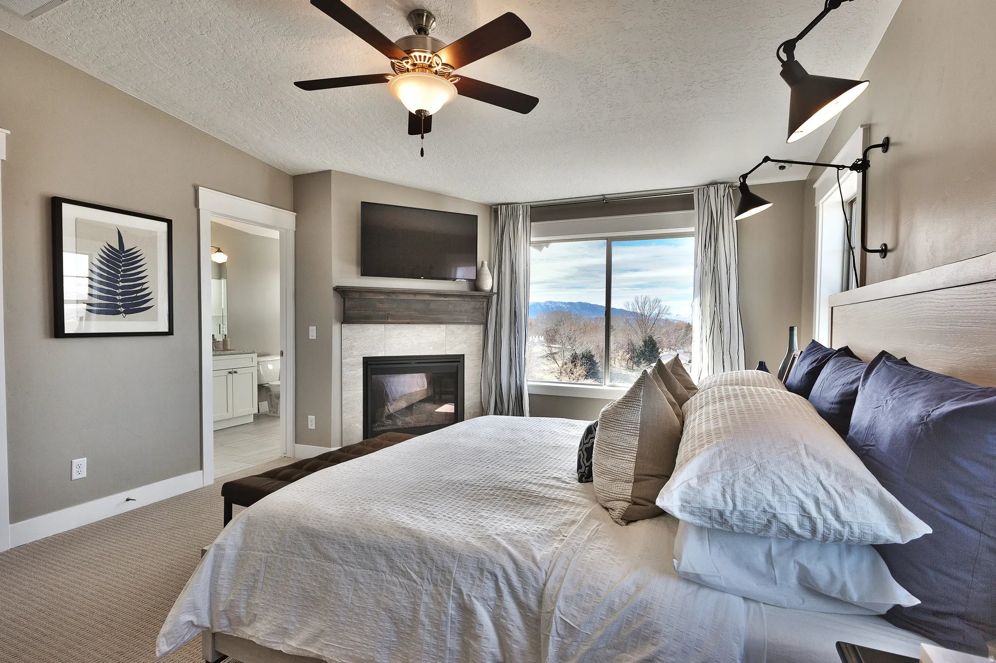 Primary Bedroom, Built-in fireplace with a tile surround and wood mantel